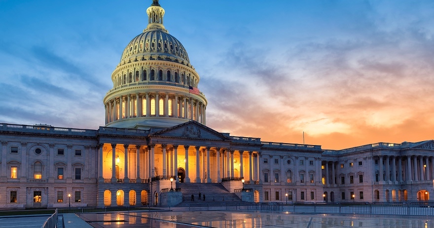 Capitol building at dusk with lights on, urging action on the growing plastic waste crisis.