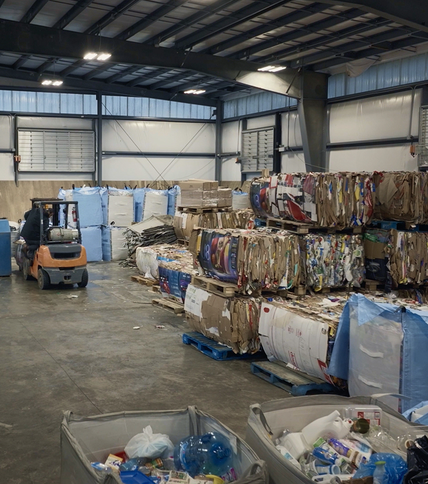 A British Columbia recycling facility processes materials, including plastic waste, into bales.