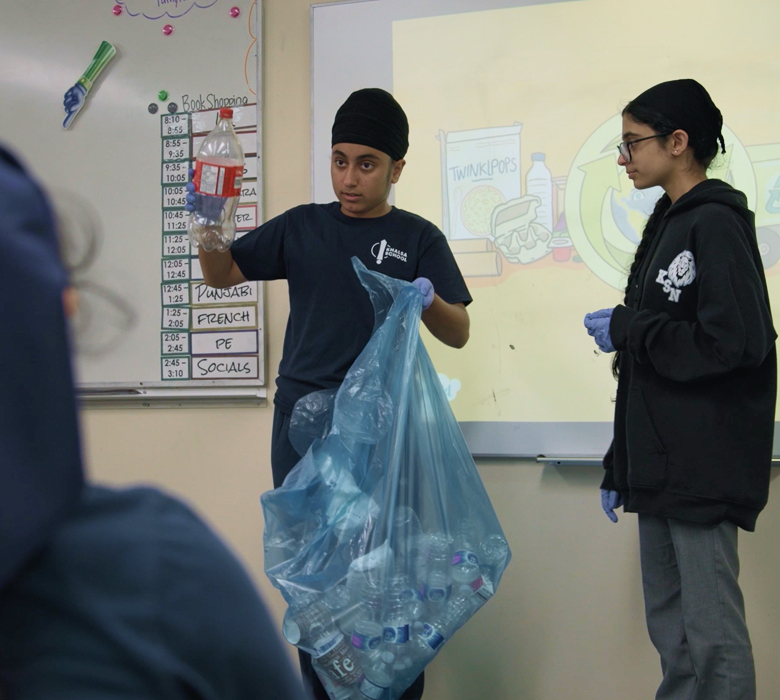 Students in a British Columbia school teach classmates about sorting plastic waste for recycling.
