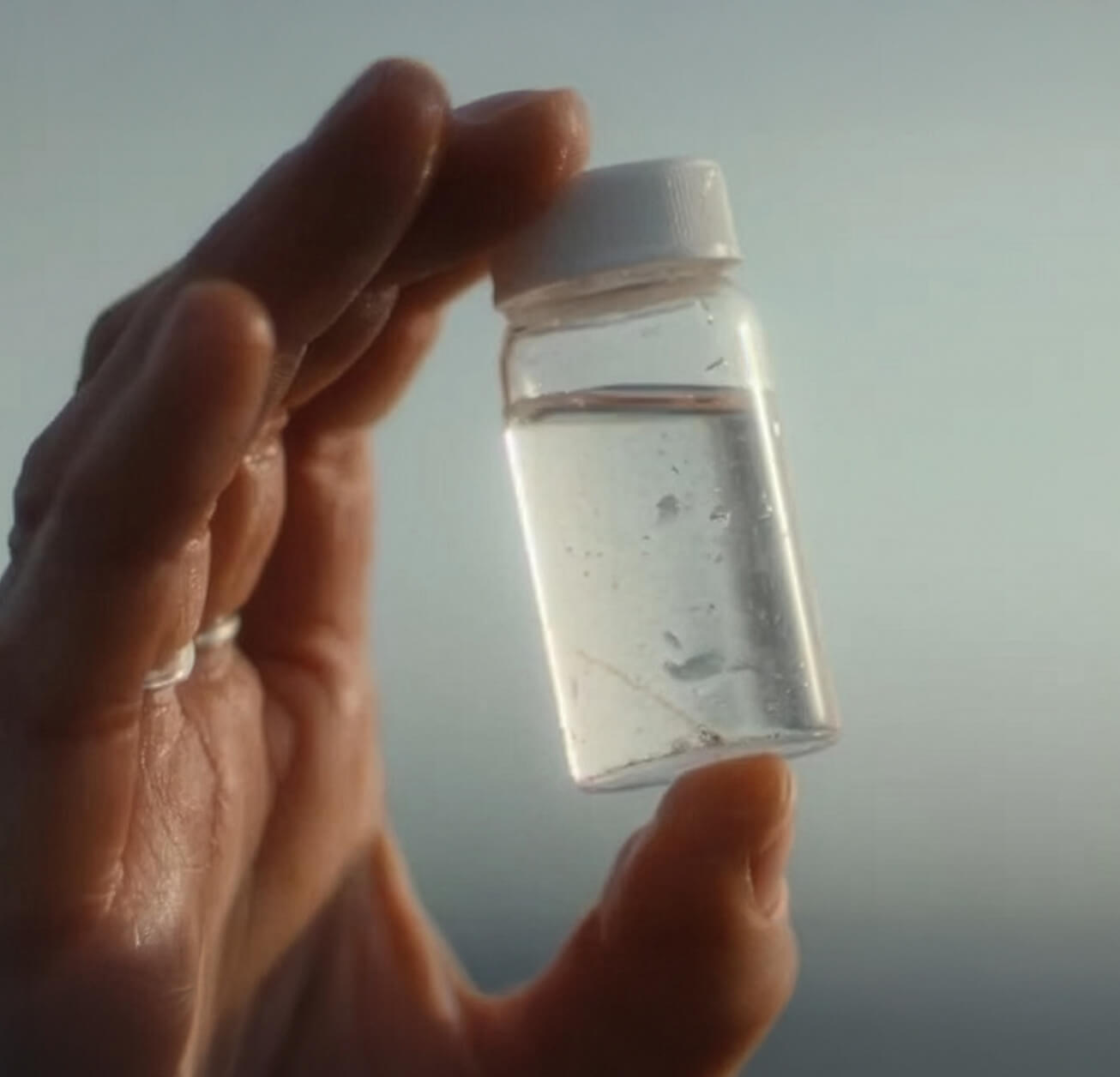 Person facing the the Gulf of Maine, highlighting the ubiquity of microplastics.