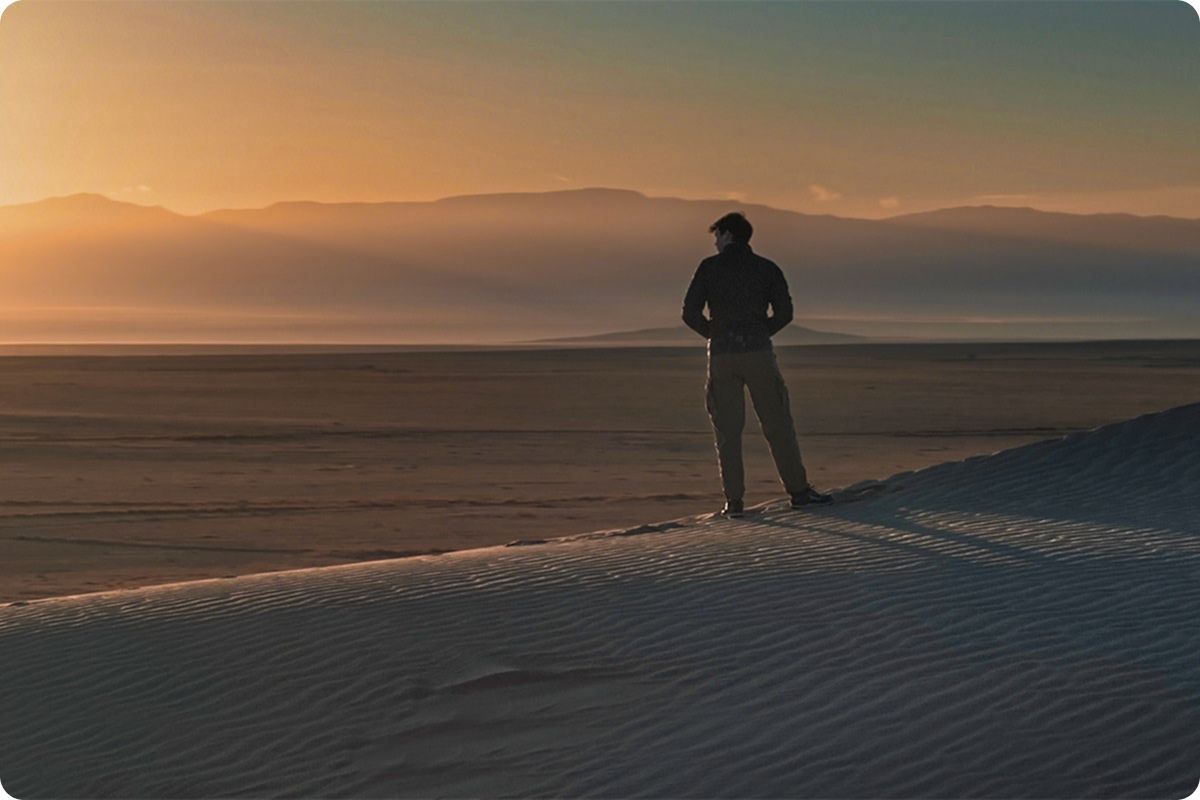 Scientist in New Mexico desert as sun rises over mountains contemplates microplastic discoveries